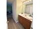 Bathroom with wood cabinets, a large mirror and views of the living area at 107 Twin Tree Dr, Summerville, SC 29485