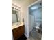 A full bathroom has wood cabinets, a large mirror, and a shower at 107 Twin Tree Dr, Summerville, SC 29485