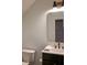 This bathroom features a modern vanity with a framed mirror, a black faucet, and a white towel at 107 Twin Tree Dr, Summerville, SC 29485