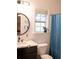 Bathroom featuring a black faucet, round mirror, shower curtain, and a window for natural light at 107 Twin Tree Dr, Summerville, SC 29485