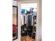Walk-in closet filled with clothes, shoes, and storage bins with wood floor and a view into the bedroom at 107 Twin Tree Dr, Summerville, SC 29485
