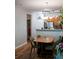 A well-lit dining area with modern lighting adjacent to a view of the kitchen at 107 Twin Tree Dr, Summerville, SC 29485