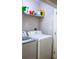 Modern laundry room featuring a side-by-side washer and dryer, and shelving for storage at 107 Twin Tree Dr, Summerville, SC 29485
