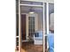 Screened-in porch with a striped loveseat, wood floors, and view into the living room and outdoors at 107 Twin Tree Dr, Summerville, SC 29485