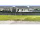 View of backyard with black fence, grass, and part of the house's screened-in porch at 110 Bloomfield St, Summerville, SC 29486