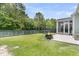 This backyard features a fire pit, a trampoline, a fenced in backyard, a patio, and a screened in porch at 110 Bloomfield St, Summerville, SC 29486