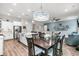 Open-concept living space with dining area features stylish lighting and a view to the spacious kitchen and comfortable living room at 110 Bloomfield St, Summerville, SC 29486