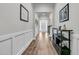 Bright foyer with hardwood floors, white wainscoting, and a view of the front door and stairway at 110 Bloomfield St, Summerville, SC 29486