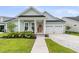 Charming single Gathering home with light blue siding, manicured lawn, and a two-car garage at 110 Bloomfield St, Summerville, SC 29486