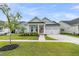 Inviting single-Gathering home with light blue siding, a well-kept lawn, and a two-car garage at 110 Bloomfield St, Summerville, SC 29486
