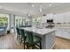 Stylish kitchen boasts an island with seating, stainless steel appliances, and sliding door access to the backyard at 110 Bloomfield St, Summerville, SC 29486