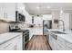Contemporary kitchen featuring white cabinets, stainless steel appliances, and stylish backsplash with hardwood flooring at 110 Bloomfield St, Summerville, SC 29486