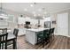 Modern kitchen features an island with bar stools, pendant lighting, and an open layout to the dining area at 110 Bloomfield St, Summerville, SC 29486