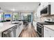 Bright kitchen open to dining area featuring an island with a stainless sink and modern appliances for cooking at 110 Bloomfield St, Summerville, SC 29486