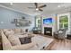 Cozy living room with a fireplace, large sectional sofa, and decoratively appointed shelves at 110 Bloomfield St, Summerville, SC 29486
