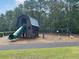 Playground with wooden playhouse, slide, swings, and spring riders on a mulch ground at 110 Bloomfield St, Summerville, SC 29486