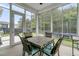 This is a screened in porch with black metal chairs and a small, dark table at 110 Bloomfield St, Summerville, SC 29486