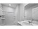 An ample bathroom featuring a shower with shelving and white vanity with a large mirror at 125 Mims Academy Dr, Harleyville, SC 29448