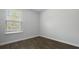 Bright bedroom with a large window and dark wood-look flooring at 125 Mims Academy Dr, Harleyville, SC 29448