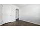 Bedroom with dark wood-look flooring, white trim, and closet at 125 Mims Academy Dr, Harleyville, SC 29448