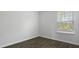 Bright bedroom featuring a window with view of lush outdoors and dark wood-look flooring at 125 Mims Academy Dr, Harleyville, SC 29448
