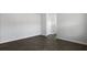 Bright bedroom with neutral walls, white trim, and dark wood-look flooring at 125 Mims Academy Dr, Harleyville, SC 29448