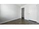 Bedroom with dark wood-look flooring, white trim, and closet at 125 Mims Academy Dr, Harleyville, SC 29448