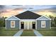 Charming duplex with gray siding, black doors, and a well-manicured lawn at 125 Mims Academy Dr, Harleyville, SC 29448
