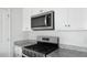 Modern kitchen features white cabinets, stainless steel appliances, and granite countertops at 125 Mims Academy Dr, Harleyville, SC 29448