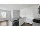 Charming kitchen with granite counters, white cabinetry, and stainless steel dishwasher at 125 Mims Academy Dr, Harleyville, SC 29448