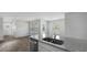 Sunlit open floor plan featuring wood floors and a kitchen with granite counters at 125 Mims Academy Dr, Harleyville, SC 29448