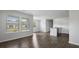 Open-concept living space with wood floors, large windows, and kitchen featuring granite counters at 125 Mims Academy Dr, Harleyville, SC 29448