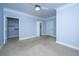Spacious bedroom features plush carpeting, a ceiling fan, closets and multiple doors at 1319 Basildon Rd, Mount Pleasant, SC 29466