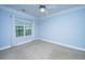 Bright bedroom with plush carpet, a ceiling fan, and a large window, offering a serene atmosphere at 1319 Basildon Rd, Mount Pleasant, SC 29466