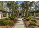 A beautiful community courtyard featuring palm trees, pergolas, and an arched portico, offering a serene and relaxing outdoor space at 1319 Basildon Rd, Mount Pleasant, SC 29466