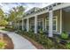 Charming porch featuring green planters and rocking chairs provides a welcoming entrance to this attractive home at 1319 Basildon Rd, Mount Pleasant, SC 29466