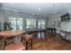 Enjoy a game of pool in the game room with hardwood floors and lots of natural light at 1319 Basildon Rd, Mount Pleasant, SC 29466