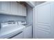 Bright laundry room featuring modern washer and dryer units and ample storage space at 1319 Basildon Rd, Mount Pleasant, SC 29466