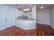 Living room with hardwood floors and white paint, and adjacent to the kitchen at 1319 Basildon Rd, Mount Pleasant, SC 29466