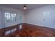 An empty living room featuring hardwood floors, ample natural light, crown moulding, and neutral wall color at 1319 Basildon Rd, Mount Pleasant, SC 29466