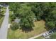 Aerial view of a charming home with a spacious yard, mature trees, and convenient street access at 1350 Mosstree Rd, North Charleston, SC 29405