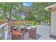 Backyard featuring a patio set, rocking chairs, and a lush, green lawn at 1350 Mosstree Rd, North Charleston, SC 29405