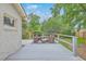 Backyard showcasing a patio set, landscaping, and a white-painted fence at 1350 Mosstree Rd, North Charleston, SC 29405