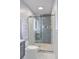 Well-lit bathroom with a glass-enclosed shower and gray tiling at 1350 Mosstree Rd, North Charleston, SC 29405