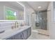 Modern bathroom with a glass shower door, a vanity with gold fixtures, and a window at 1350 Mosstree Rd, North Charleston, SC 29405