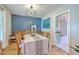 Bright and open dining area with stylish light fixture, wood paneling, and hardwood floors at 1350 Mosstree Rd, North Charleston, SC 29405