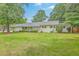 Charming single-story brick home with a well-maintained lawn and mature trees, offering classic curb appeal at 1350 Mosstree Rd, North Charleston, SC 29405