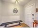 Welcoming foyer with a dark wooden bench, light fixture, personal signage, and hardwood floors at 1350 Mosstree Rd, North Charleston, SC 29405