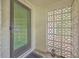 Close-up of the home's entrance, highlighting the unique breezeblock wall and classic storm door at 1350 Mosstree Rd, North Charleston, SC 29405
