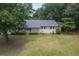 Charming single-story home with a well-manicured front yard and lush greenery, offering a welcoming curb appeal at 1350 Mosstree Rd, North Charleston, SC 29405